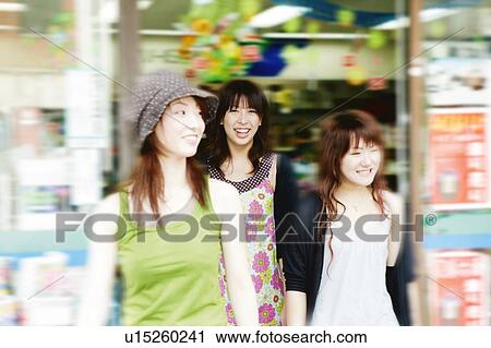 Stock Image - Three Young Adult Women shopping. Fotosearch