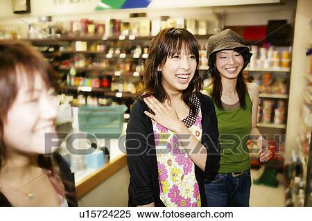 Stock Photography - Three Young Adult Women shopping. Fotosearch