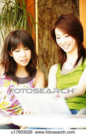 Stock Photograph - Two Young Adult Women at the caf?. Fotosearch