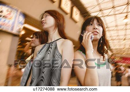 Stock Photo - Two Young Adult Women Shopping. Fotosearch