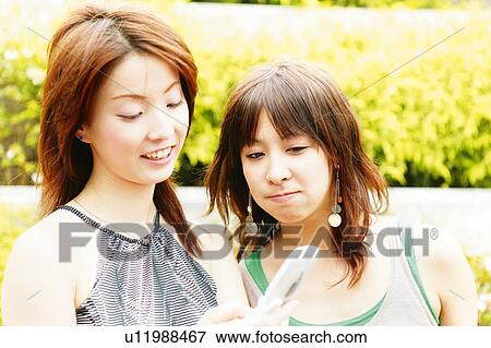 Stock Photo - Two Young Adult Women . Fotosearch