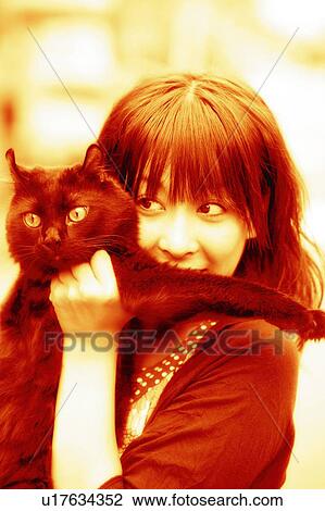 Stock Image - Young Adult Woman and a Cat. Fotosearch