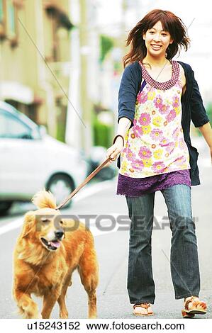 Stock Image - Young Adult Woman and a Dog. Fotosearch