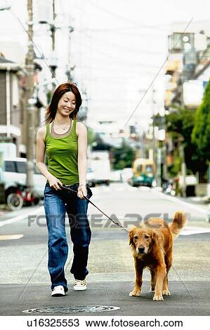 Stock Image - Young Adult Woman and a Dog. Fotosearch