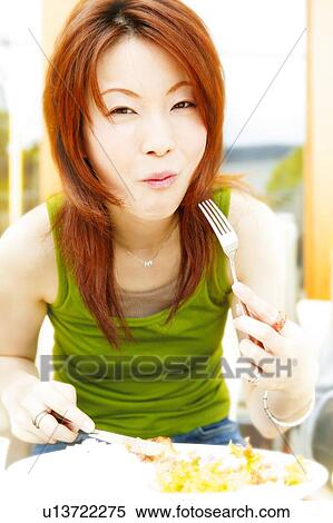 Young Adult Woman Eating a Food View Large Photo Image Stock Photography - Young Adult Woman Eating a Food. Fotosearch