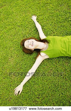 Stock Photo - Young Adult Woman Lying Down. Fotosearch