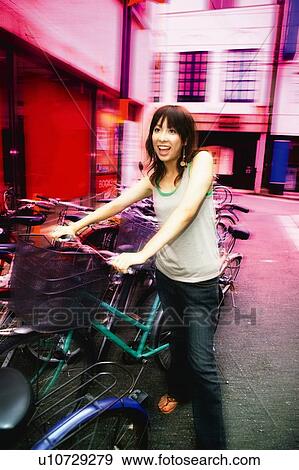 Young Adult Woman Parking a Bicycle View Large Photo Image Stock Photo - Young Adult Woman Parking a Bicycle. Fotosearch