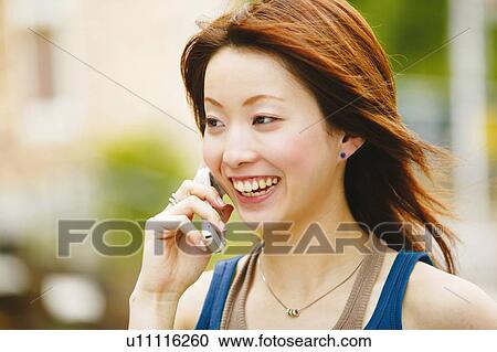 Young Adult Woman talking on the phone View Large Photo Image Stock Image - Young Adult Woman talking on the phone. Fotosearch