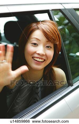 Stock Photograph - Young Adult Woman waving a hand. Fotosearch