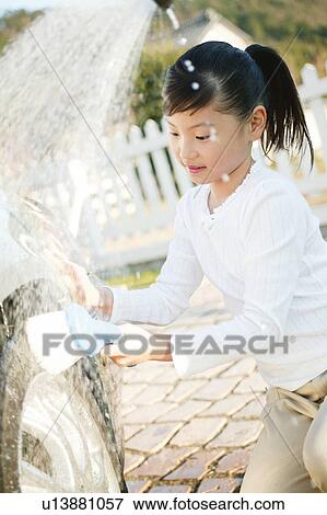 Stock Photo - Child helping to wash a car. Fotosearch