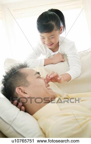 Stock Image - Child waking up her father. Fotosearch