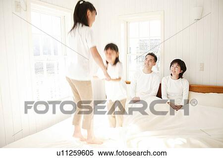 Stock Photography - Children Jumping on the bed. Fotosearch