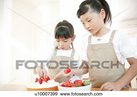Stock Photo - Children making a cake. Fotosearch
