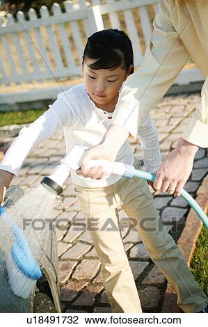 Father and child washing a car View Large Photo Image Stock Image - Father and child washing a car. Fotosearch