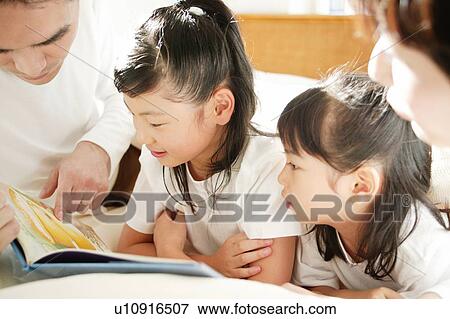 Stock Photo - Father reading a book for children. Fotosearch