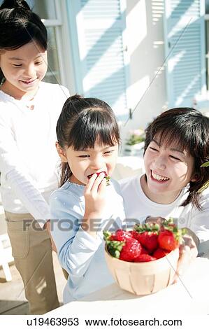 Girl eating strawberries View Large Photo Image Stock Image - Girl eating strawberries. Fotosearch