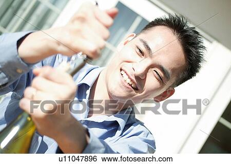 Man opening a wine View Large Photo Image Stock Photograph - Man opening a wine. Fotosearch