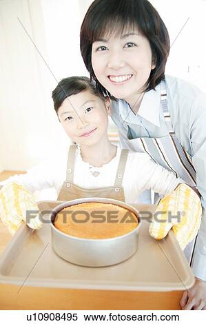 Stock Photography - Mother and child making a cake. Fotosearch