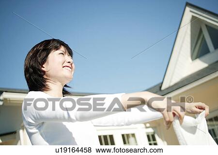 Stock Photo - Woman washing clothes. Fotosearch