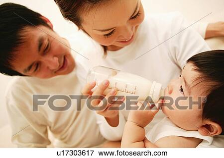Stock Photo - A Baby drinking a milk. Fotosearch
