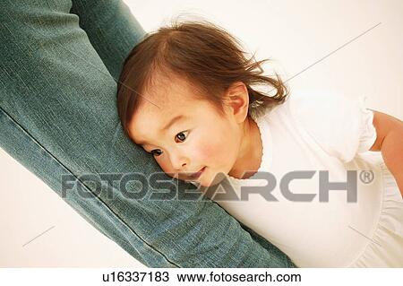 A Baby Girl Holding her mother's feet View Large Photo Image Stock Image - A Baby Girl Holding her mother's feet. Fotosearch