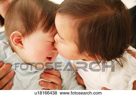 Stock Photo - A Baby Girl kissing. Fotosearch