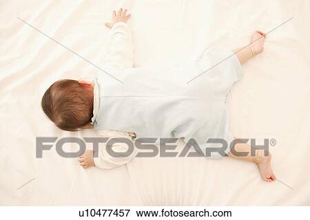 Stock Photo - A Baby Girl sleeping peacefully. Fotosearch