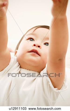 Stock Image - A Baby Girl streching her arms. Fotosearch