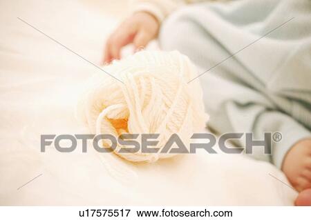 A Baby Girl's Hand and a bowl of yarn View Large Photo Image Stock Photo - A Baby Girl's Hand and a bowl of yarn. Fotosearch