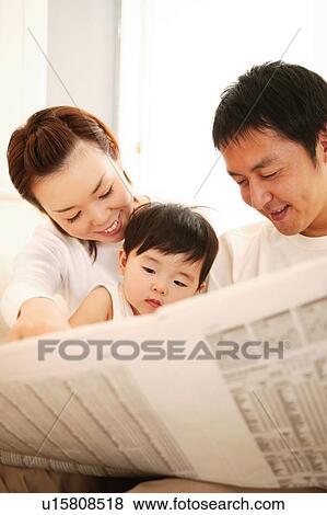 Stock Photo - Family in the living room. Fotosearch