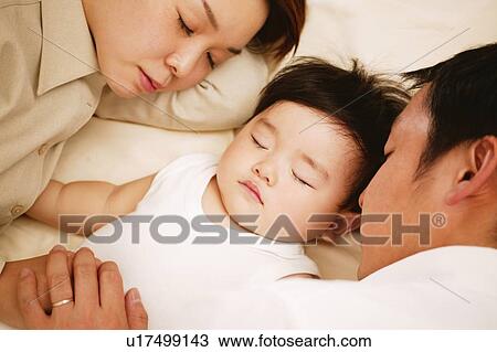 Stock Image - Family sleeping together. Fotosearch