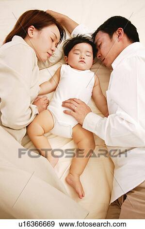 Family sleeping together View Large Photo Image Stock Photo - Family sleeping together. Fotosearch