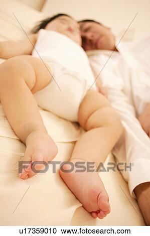 Stock Image - Father sleeping with his Baby. Fotosearch