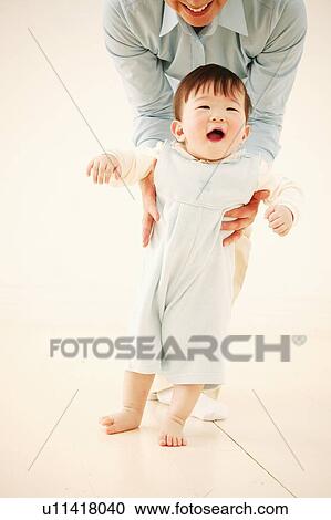 Stock Image - Mother holding her daughter. Fotosearch
