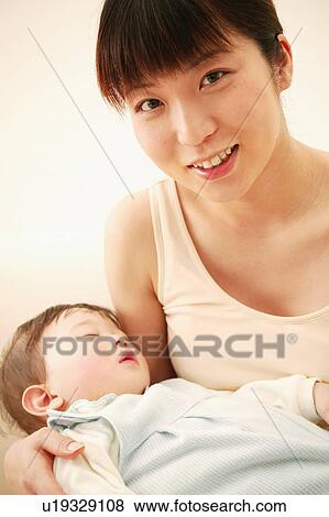 Stock Photo - Mother holding her son. Fotosearch