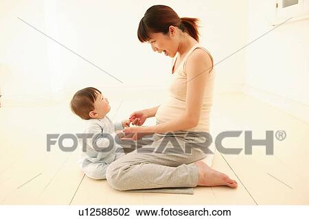 Pregnant Woman and her daughter View Large Photo Image Stock Image - Pregnant Woman and her daughter. Fotosearch