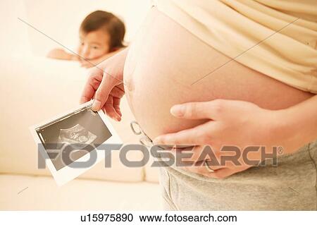 Pregnat Woman and her daughter View Large Photo Image Stock Image - Pregnat Woman and her daughter. Fotosearch