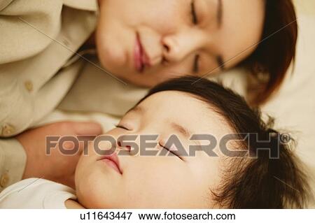Young mother and her baby sleeping together View Large Photo Image Stock Photo - Young mother and her baby sleeping together. Fotosearch