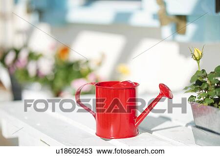 Stock Image - A Red Watering can. Fotosearch