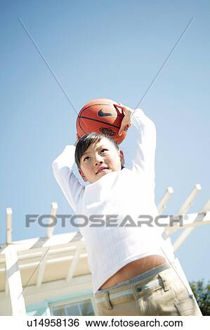 A Young Girl playing a basketball View Large Photo Image Stock Photograph - A Young Girl playing a basketball. Fotosearch