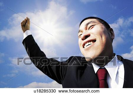 Stock Image - Businessman Raising Arm. Fotosearch