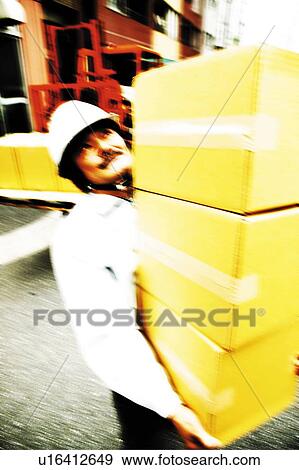 Stock Photo - Construction Worker Carrying Box. Fotosearch