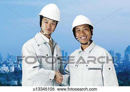 Stock Photography - Construction Workers Holding Hands. Fotosearch