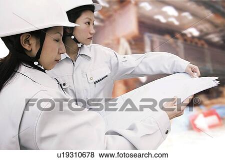 Stock Photo - Construction Workers Looking Blueprint. Fotosearch