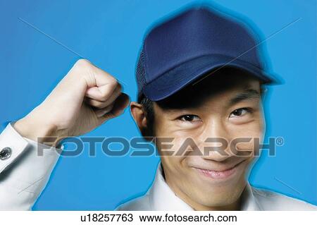 Stock Image - Delivery Man Posing, Looking at Camera. Fotosearch