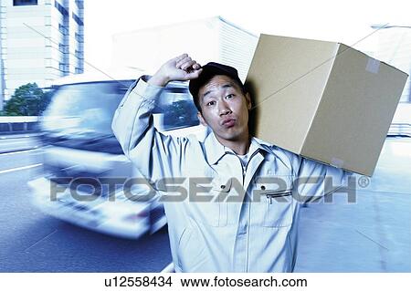 Young Delivery Man Carrying Package View Large Photo Image Picture - Young Delivery Man Carrying Package. Fotosearch