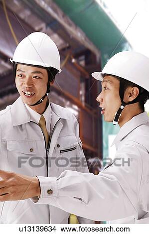 Young Workers Talking View Large Photo Image Picture - Young Workers Talking. Fotosearch