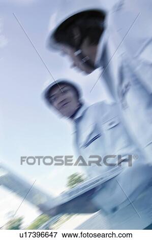 Young Workers Talking View Large Photo Image Stock Photo - Young Workers Talking. Fotosearch