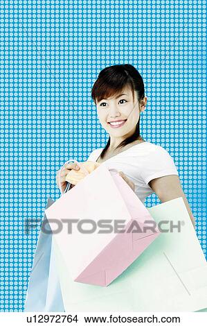 Young Woman Holding Shopping Bag View Large Photo Image Picture - Young Woman Holding Shopping Bag. Fotosearch