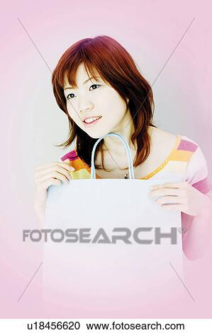 Young Woman Holding Shopping Bag View Large Photo Image Stock Image - Young Woman Holding Shopping Bag. Fotosearch